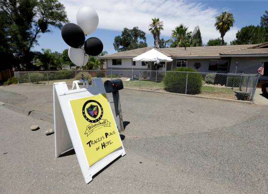 Silver and black balloons flutter in the breeze outside Tracey's Place of Hope on Thursday, Jul ...