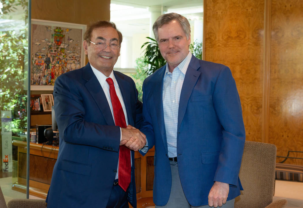 Phil Ruffin, left, shakes hands with MGM Resorts International CEO Jim Murren on Monday, Oct. 1 ...