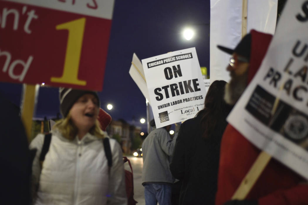 Chicago Public Schools teachers picket early Thursday morning, Oct. 17, 2019, at Lane Tech High ...