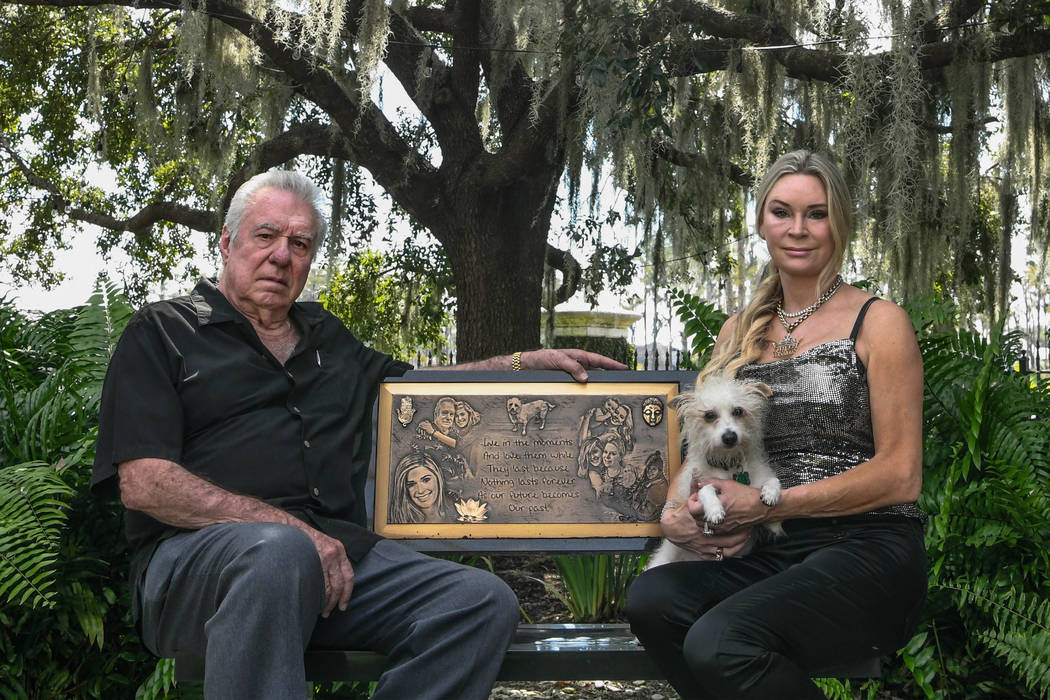 David and Jackie Siegel sit on a memorial bench made for their daughter Victoria in the backyar ...