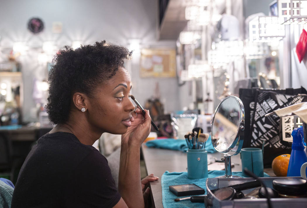 "Vegas! The Show" dancer Lauren Clark applies her makeup in the dressing room before ...