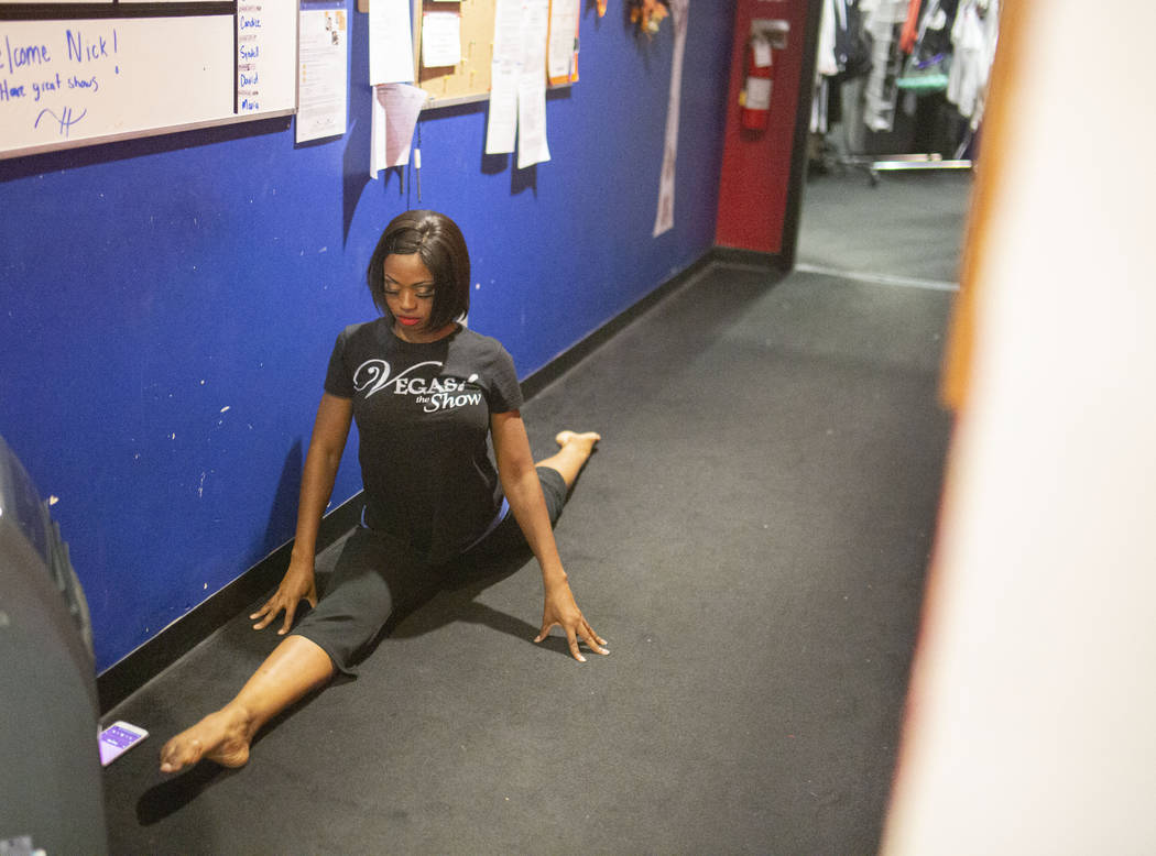 "Vegas! The Show" dancer Lauren Clark stretches before a show, backstage of the Saxe ...