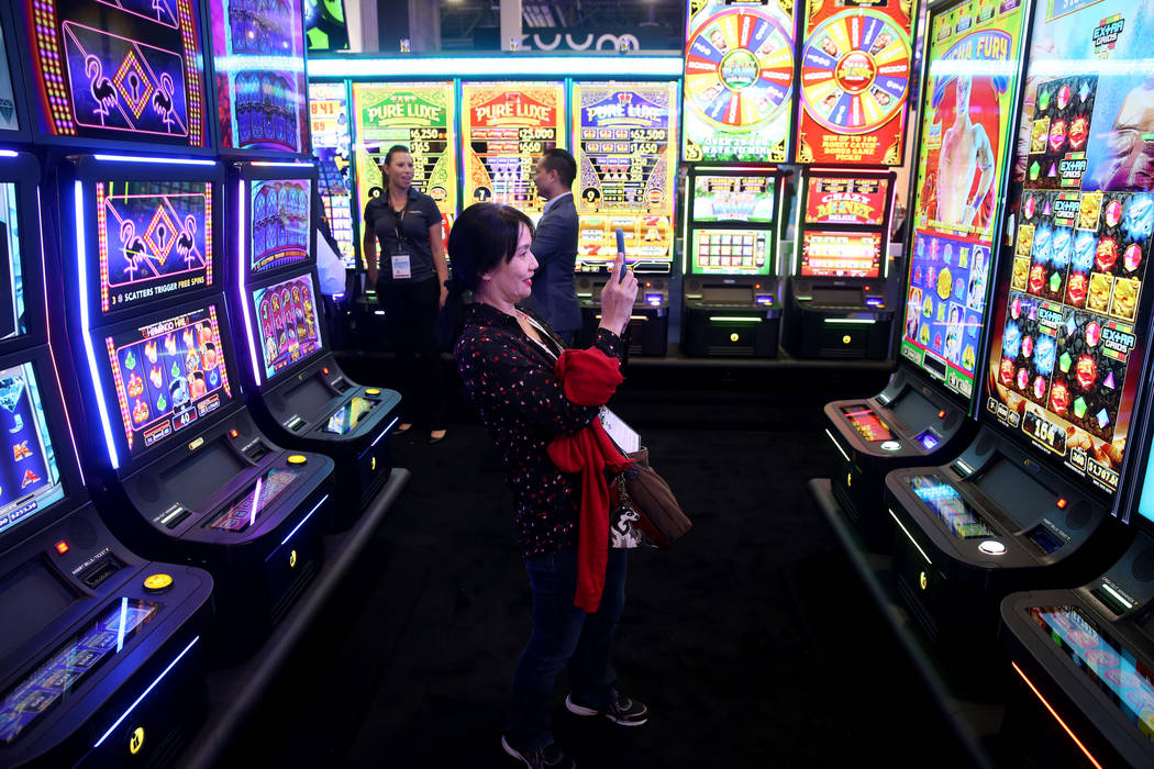 Sandy Chang-Adair of Las Vegas takes a photo at the Incredible Technologies booth at the 2019 G ...