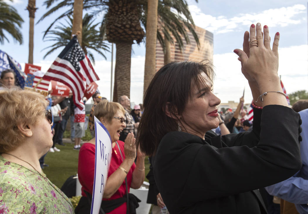 Ryon Urso of Southern Highlands claps for honking vehicles outside Trump International Hotel at ...