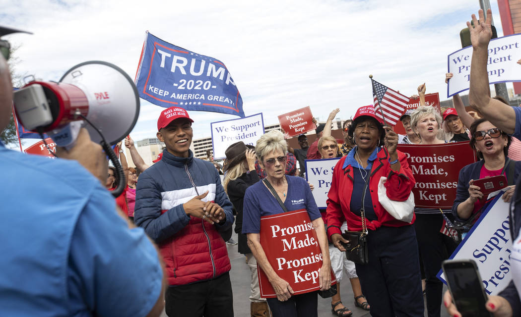 Trump supporters chant as they wait for the crosswalk to turn on Thursday, Oct. 17, 2019, in La ...