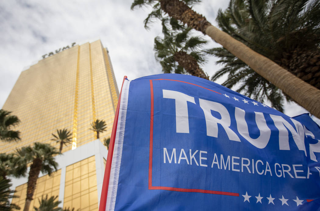 Trump merchandise, including flags, is displayed by supporters at the March for Trump on Thursd ...