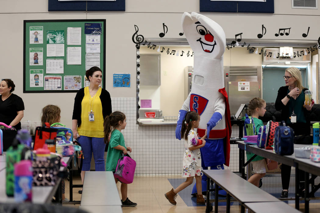 Clark County School District food services mascot Sporky high-fives students at Staton Elementa ...