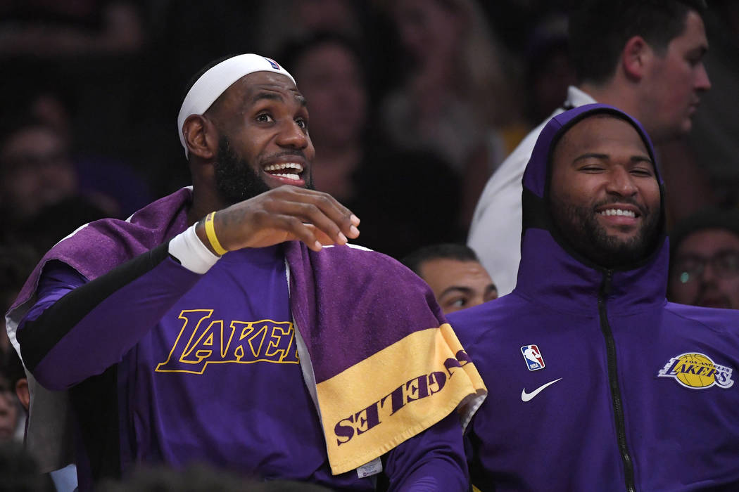 Los Angeles Lakers forward LeBron James, left, jokes around with center DeMarcus Cousins on the ...