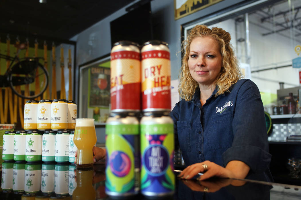 Owner of CraftHaus Brewery Wyndee Forrest displays their in house craft beer in cans which has ...