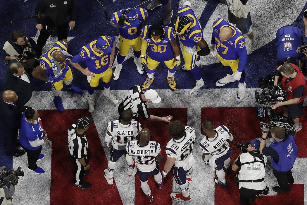 Referee John Parry (132) displays the coin before the coin toss ahead of the NFL Super Bowl 53 ...