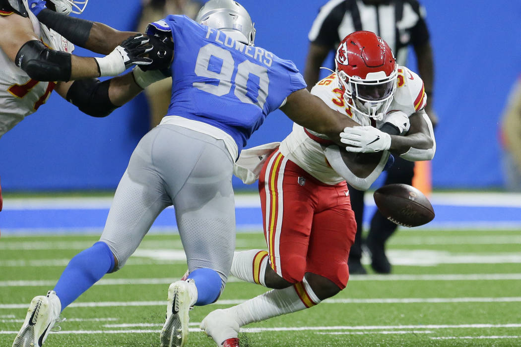 Detroit Lions defensive end Trey Flowers (90) knocks the ball out of the arms of Kansas City Ch ...