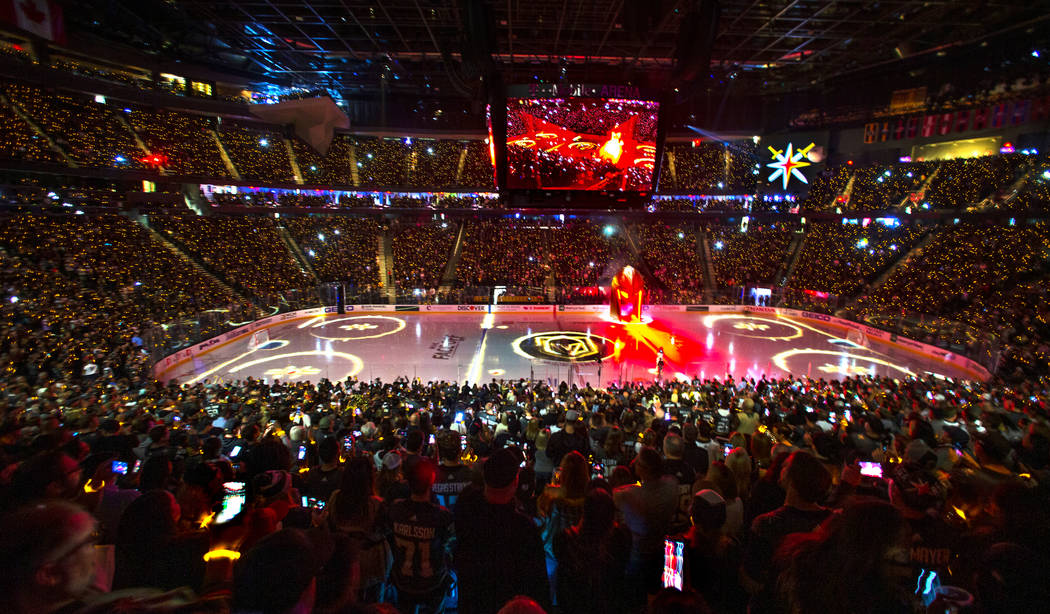 Lighted bracelets twinkle on the wrists of Vegas Golden Knights fans before the start of the fi ...