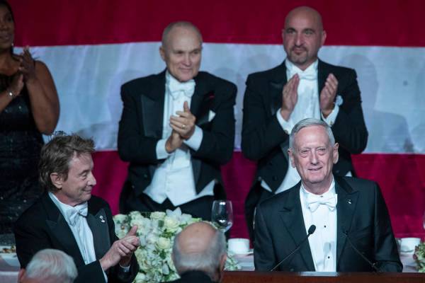 Former U.S. Secretary of Defense Jim Mattis, right foreground, receives a standing ovation duri ...