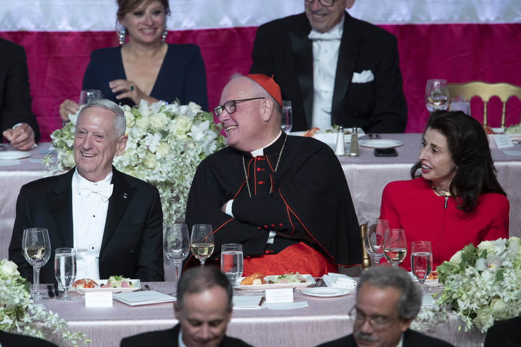 Former U.S. Secretary of Defense Jim Mattis, left, Cardinal Timothy Dolan, center, and 2019 Hap ...