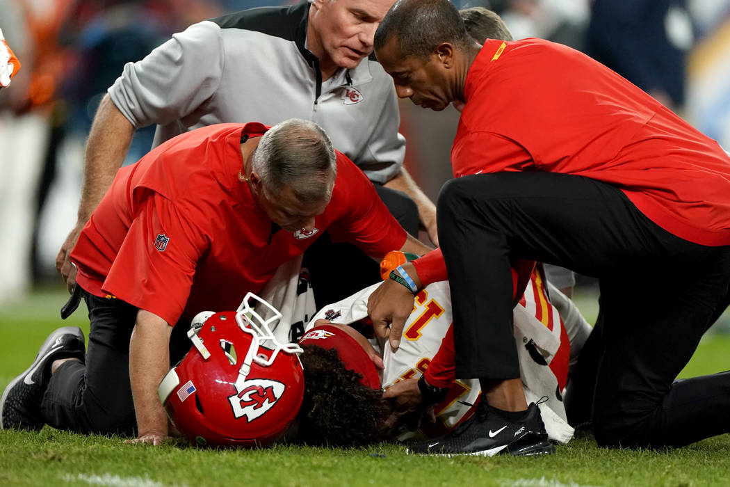 Kansas City Chiefs quarterback Patrick Mahomes (15) is helped by trainers after getting injured ...