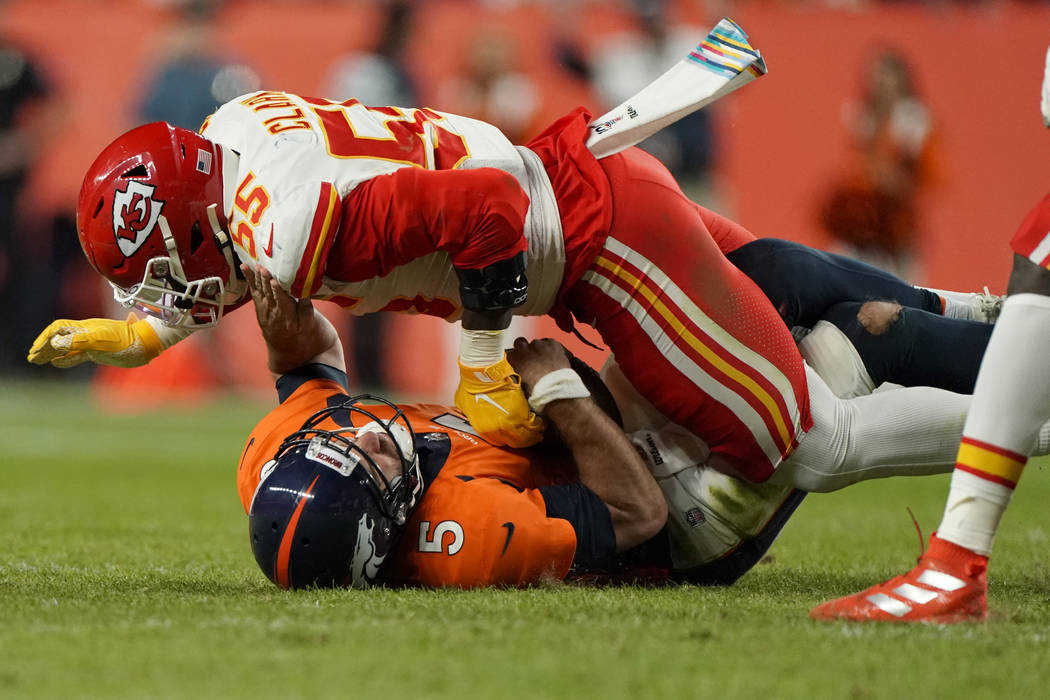 Denver Broncos quarterback Joe Flacco (5) is sacked by Kansas City Chiefs defensive end Frank C ...