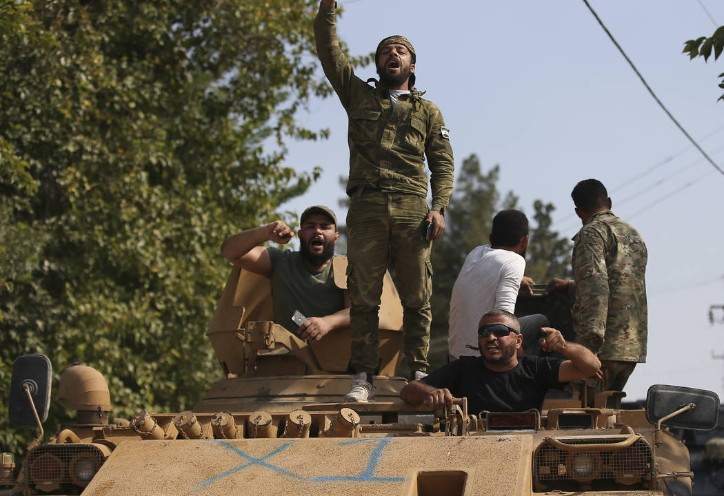 Turkish-backed Syrian opposition fighters on an armoured personnel carrier chant slogans as the ...