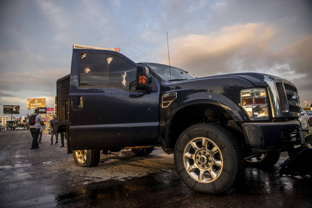 A truck's windows shows hits from bullets after a gunfight in Culiacan, Mexico, Thursday, Oct. ...