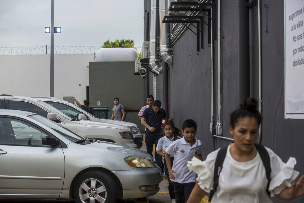 People take cover during a shoutout in Culiacan, Mexico, Thursday, Oct. 17, 2019. An intense gu ...