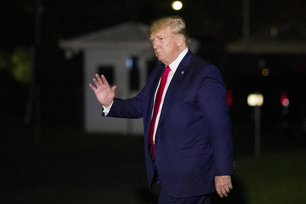 President Donald Trump waves after stepping off Marine One on the South Lawn of the White House ...