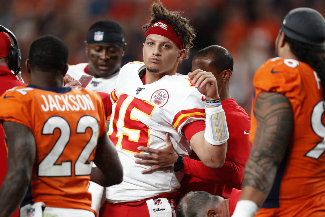 Kansas City Chiefs quarterback Patrick Mahomes (15) is helped off the field after being injured ...