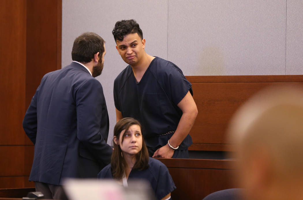 Henry Aparicio, 23, who is accused in a DUI crash that killed a man and a woman, talks to his a ...