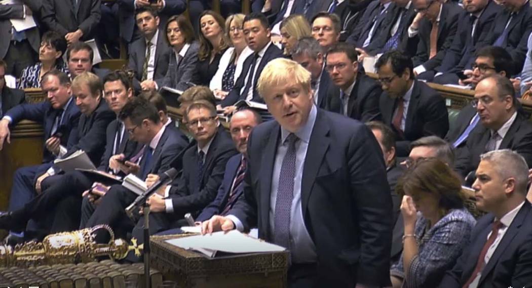 Britain's Prime Minister Boris Johnson delivers a statement to lawmakers inside the House of Co ...