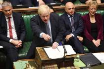 Britain's Prime Minister Boris Johnson speaks to lawmakers inside the House of Commons to updat ...