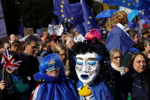 Anti-Brexit protestors march in London, Saturday, Oct. 19, 2019. In their first weekend session ...