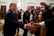 President Donald Trump reaches to shake hands during a reception for Italian President Sergio M ...