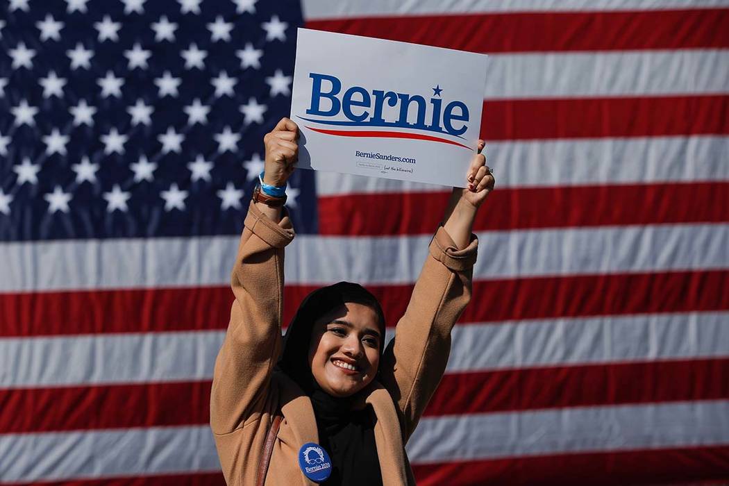 A woman attends a rally for Democratic presidential candidate Sen. Bernie Sanders, I-Vt., on Sa ...