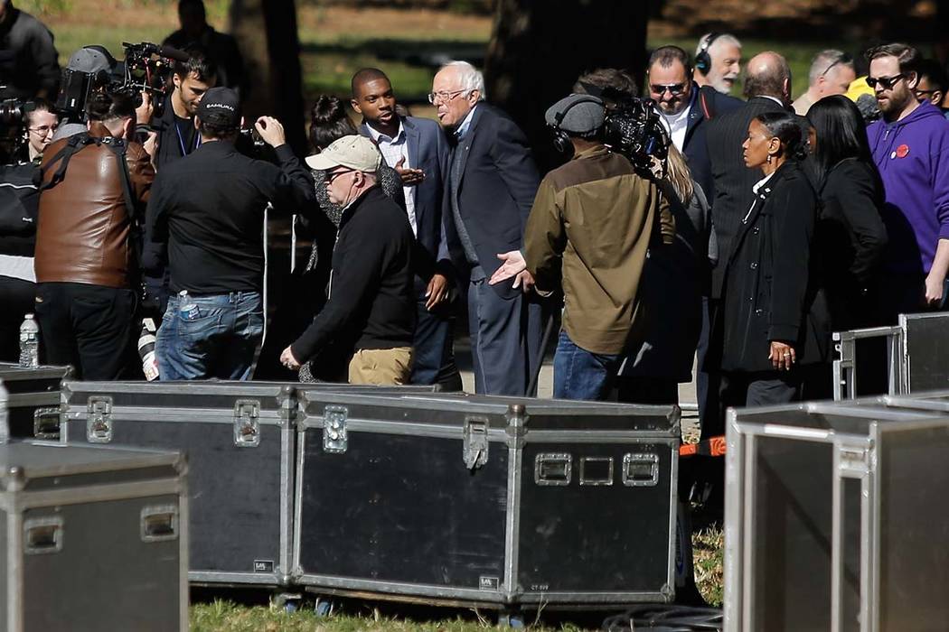 Democratic presidential candidate Sen. Bernie Sanders, I-Vt., (C) arrives to attend a rally on ...