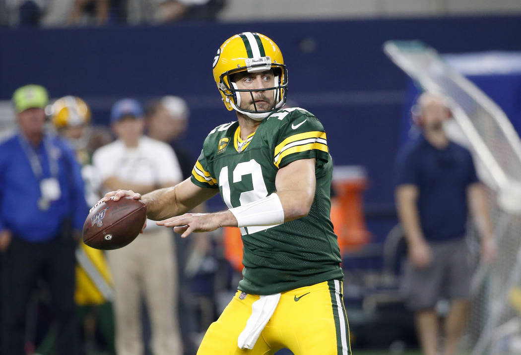 Green Bay Packers quarterback Aaron Rodgers (12) prepares to throw a pass during an NFL footbal ...