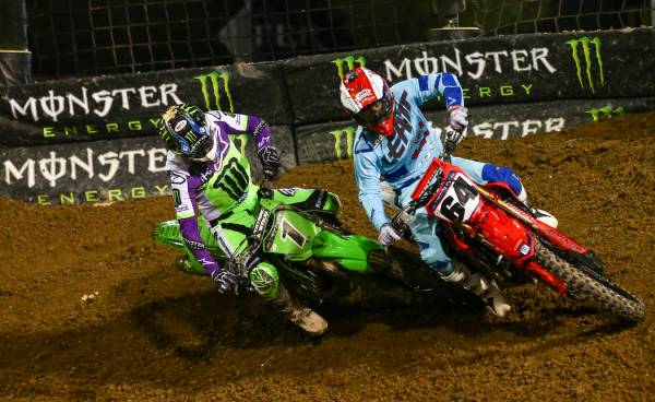 Eli Tomac (1) and Vince Friese (64) battle for position during the first round of the Monster E ...