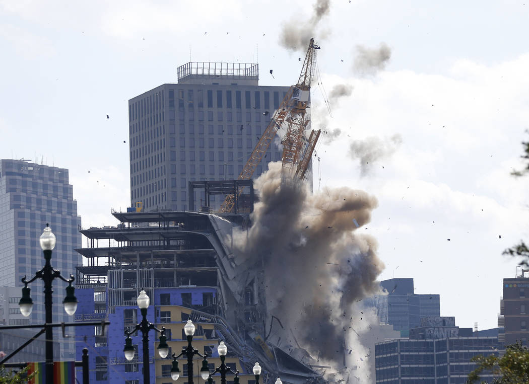 Two large cranes from the Hard Rock Hotel construction collapse come crashing down after being ...