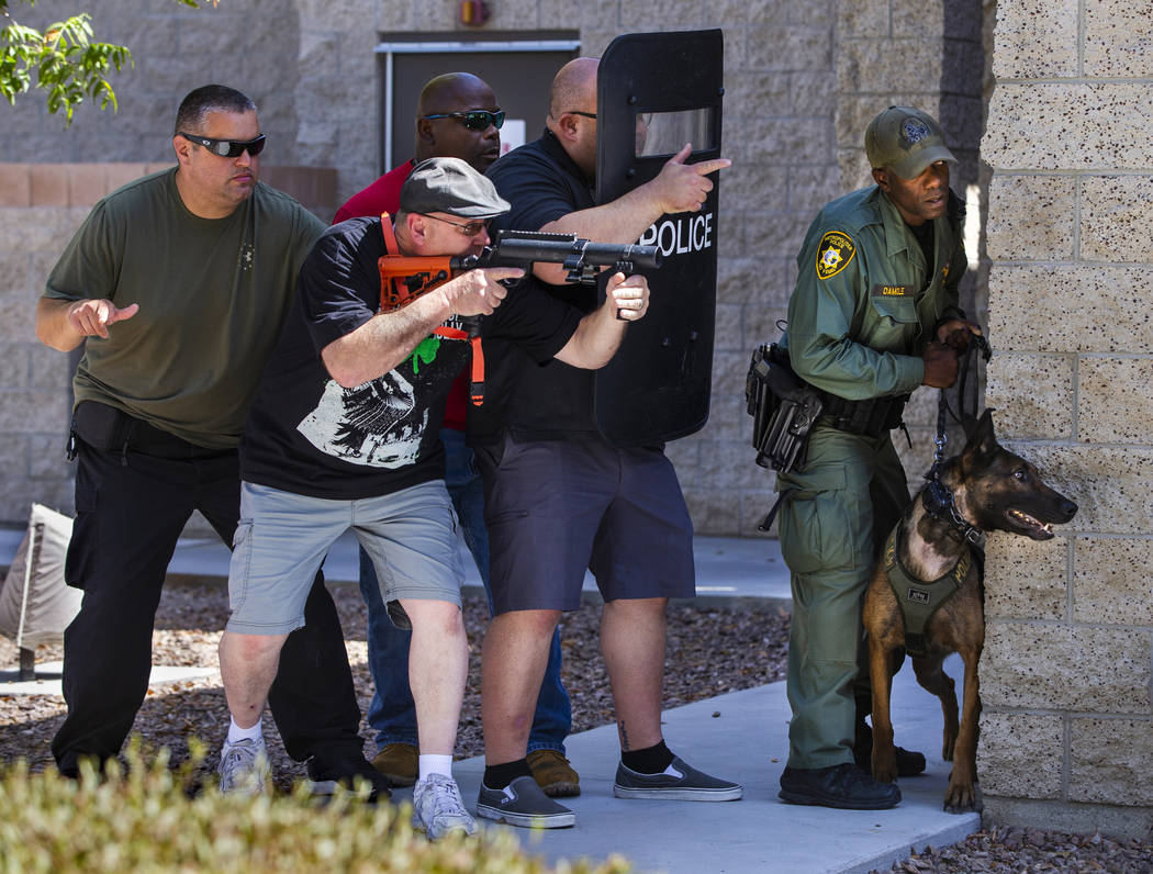 A Las Vegas police officer with a 40 mm Launcher, a new less-than-lethal weapon, joins other "a ...