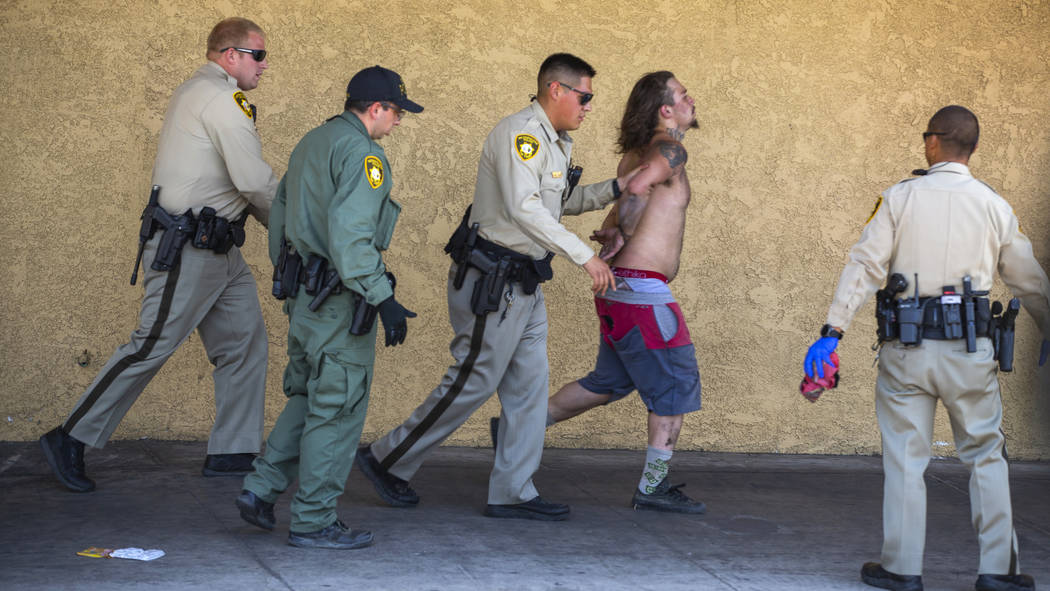 Metropolitan Police Department officers arrest a stabbing suspect after a short chase near down ...