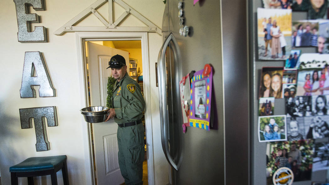 Las Vegas police K-9 officer Jason Dukes prepares food for his K-9 partners at his home in Hend ...