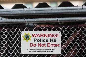 A warning sign on kennels at the Henderson home of Las Vegas police K-9 officer Jason Dukes on ...