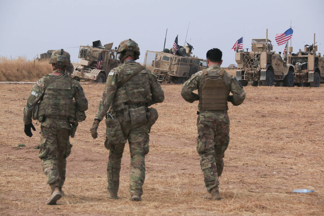 American military convoy stops near the town of Tel Tamr, north Syria, Sunday, Oct. 20, 2019. K ...