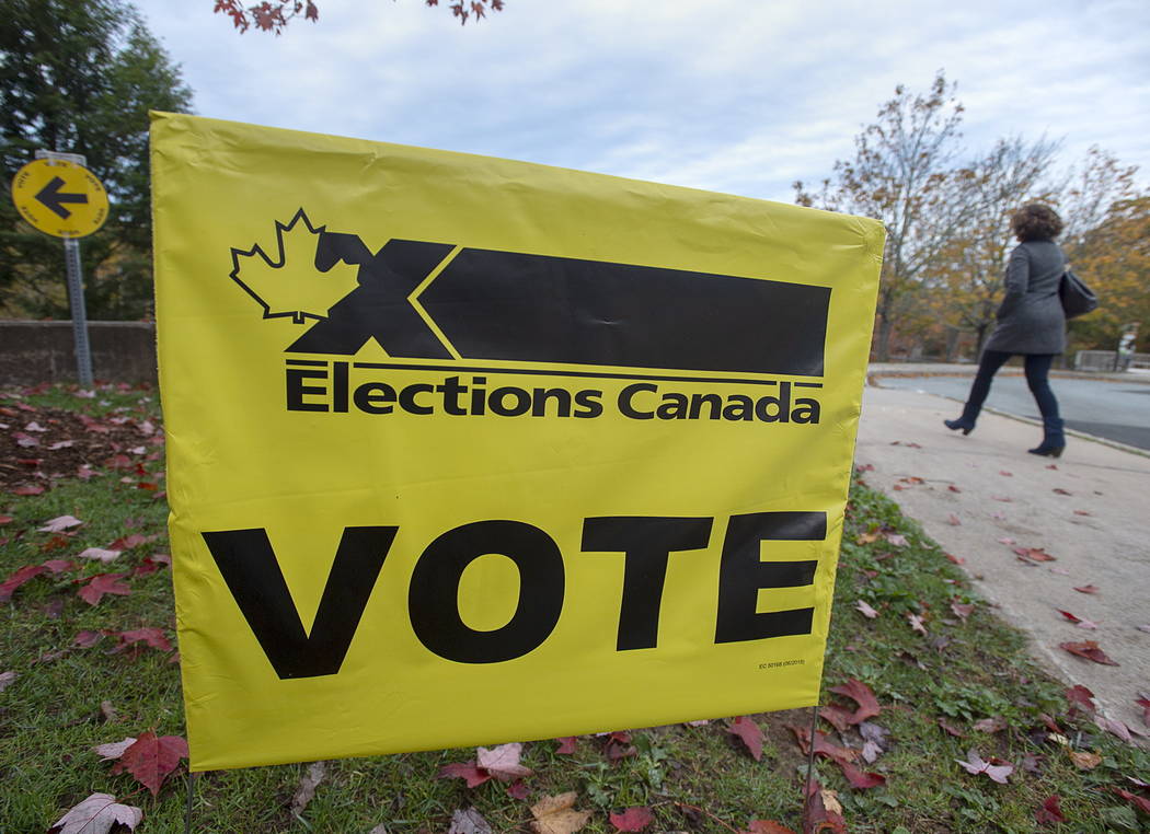 A voter heads to cast their vote in Canada's federal election at the Fairbanks Interpretation C ...