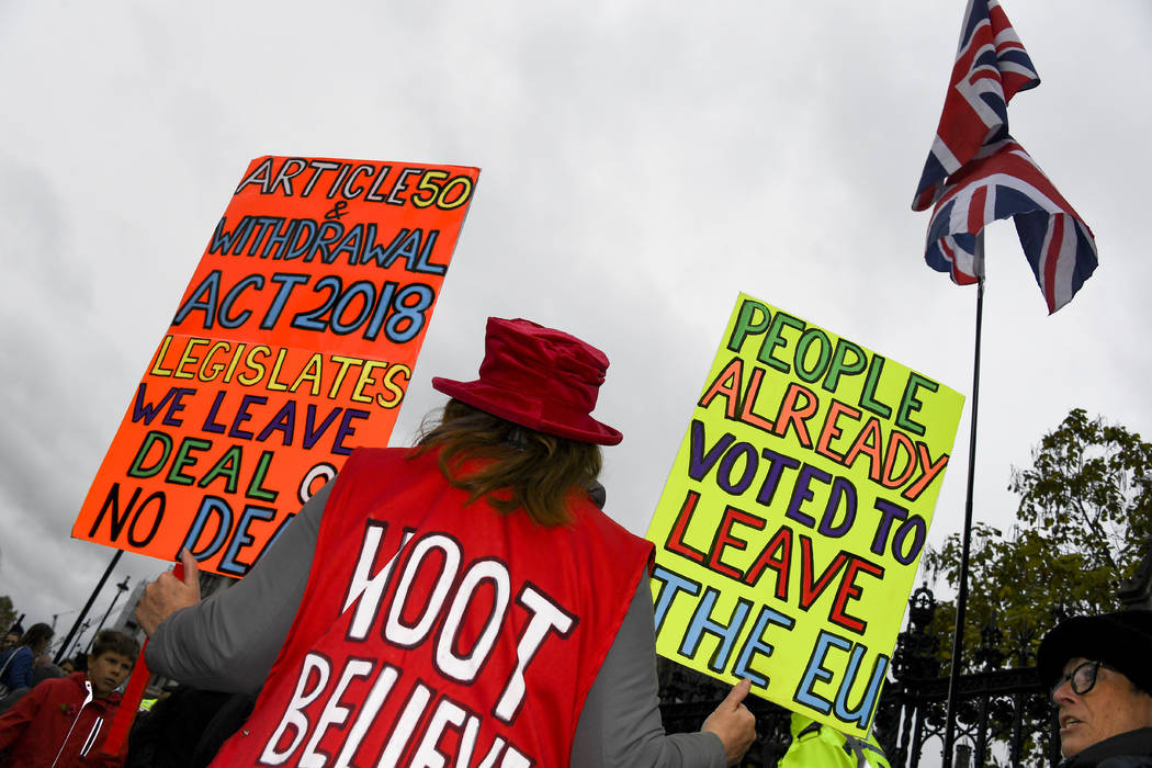 Pro Brexit demonstrators gather outside the Houses of Parliament holding placards and waving Un ...