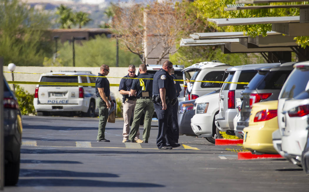 Officers work the scene of an officer-involved shooting at The Equestrian on Eastern Apartments ...