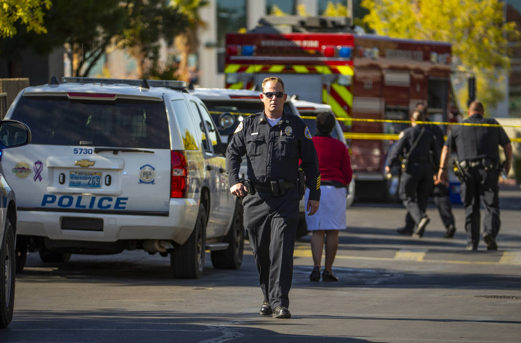 Officers work the scene of an officer-involved shooting at The Equestrian on Eastern Apartments ...