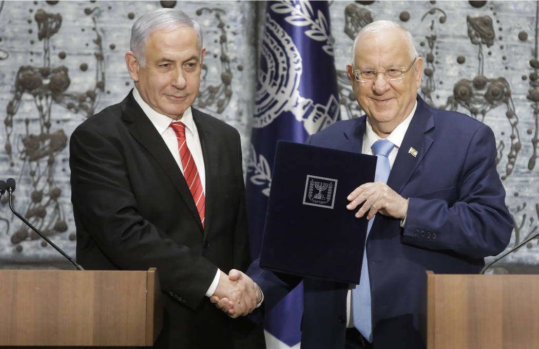 FILE - In this Sept. 25, 2109 file photo, Israeli President Reuven Rivlin, right, shakes hands ...