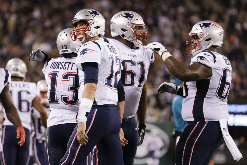 New England Patriots' Tom Brady (12) celebrates with Phillip Dorsett (13) after they connected ...