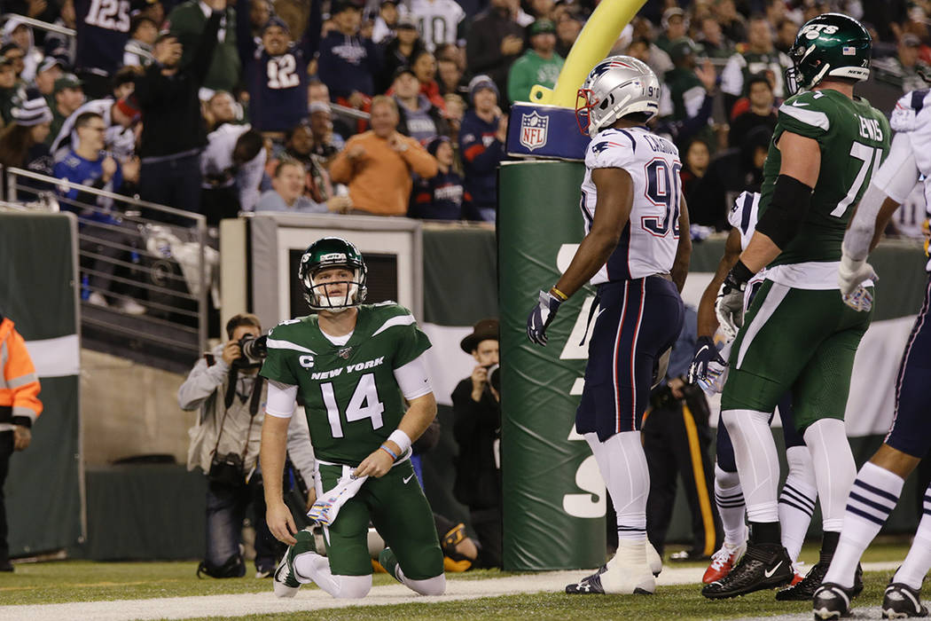 New York Jets quarterback Sam Darnold (14) reacts after the New England Patriots scored a safet ...