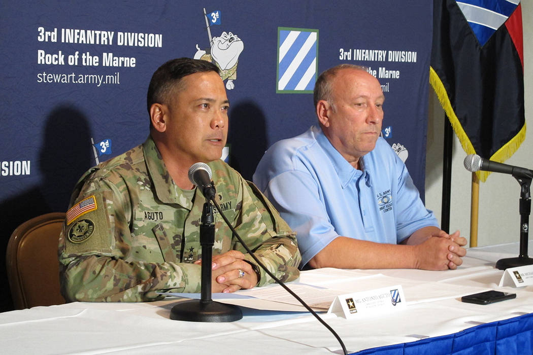 Army Maj. Gen. Antonio Aguto, left, and Army accident investigator Michael Barksdale hold a new ...