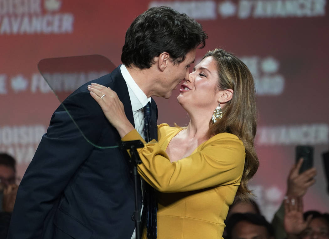 Liberal leader Justin Trudeau and wife Sophie Gregoire Trudeau kiss as they celebrate on stage ...