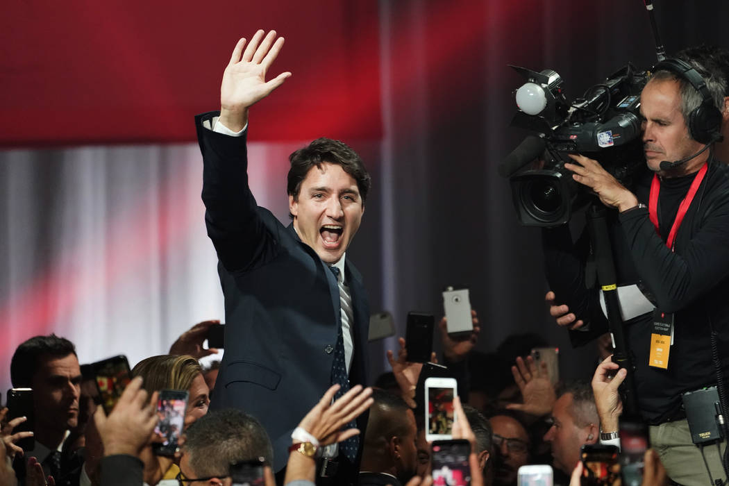 Liberal leader Justin Trudeau waves as he goes on stage at Liberal election headquarters in Mon ...
